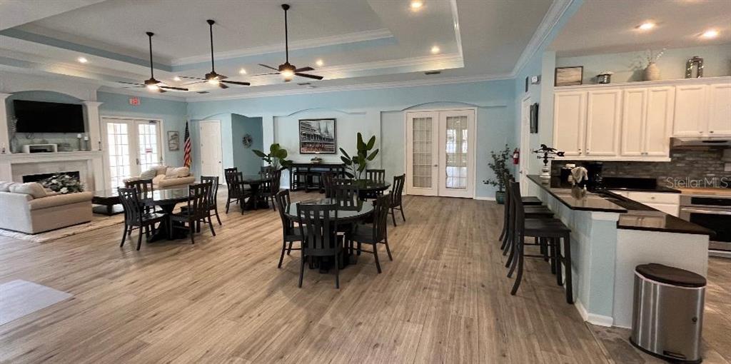 5856 Count Turf Lane Wesley Chapel, FL 33544 - Photo 47 of 57 a view of a dining room with furniture window and wooden floor