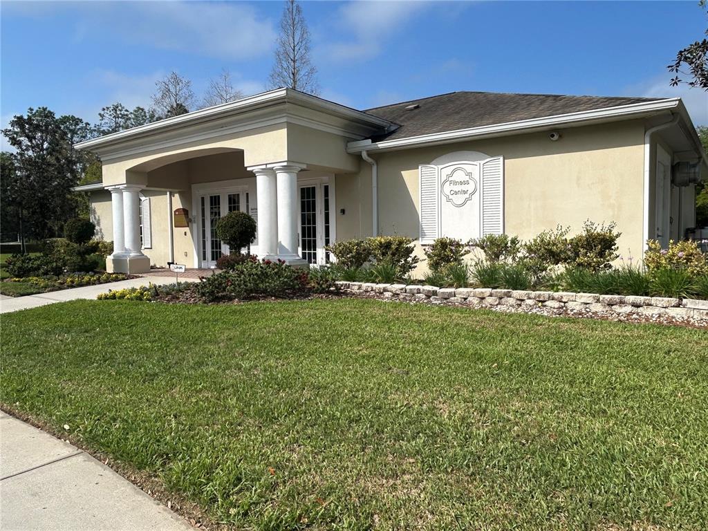 5856 Count Turf Lane Wesley Chapel, FL 33544 - Photo 48 of 57 a front view of a house with a yard