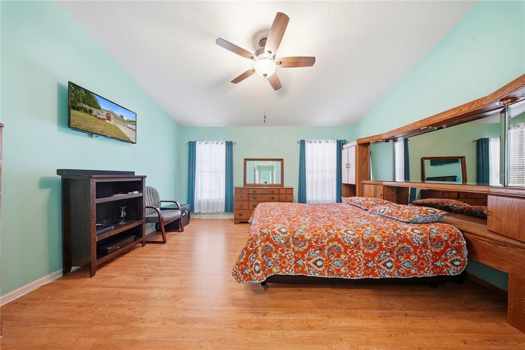 5856 Count Turf Lane Wesley Chapel, FL 33544 - Photo 5 of 57 a bedroom with a bed couch and dresser