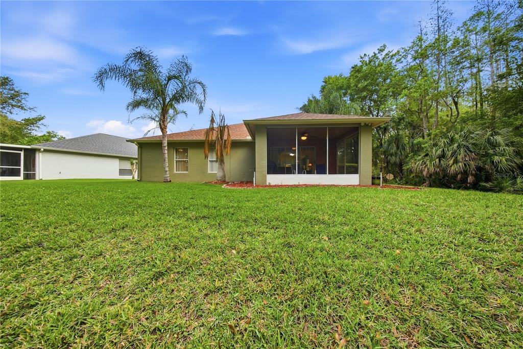 5856 Count Turf Lane Wesley Chapel, FL 33544 - Photo 8 of 57 a front view of a house with a garden and yard