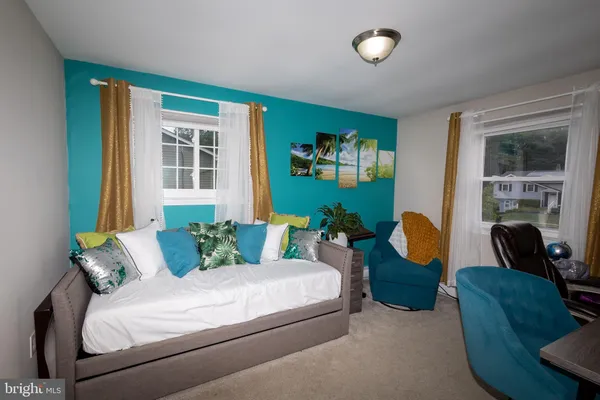 a bedroom with bed and a couch