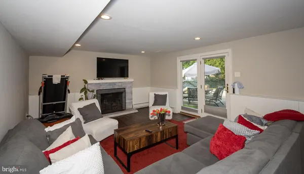 a living room with furniture fireplace and flat screen tv