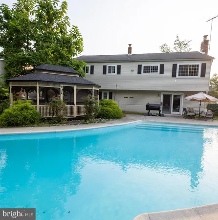 a front view of a house with porch yard and swimming pool