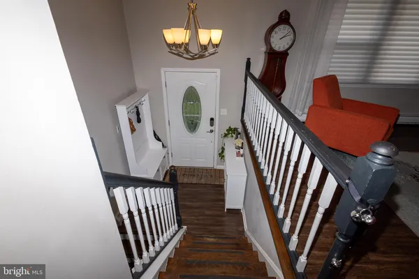 a view of entryway and hall with wooden floor