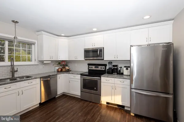 a kitchen with a refrigerator stove and sink