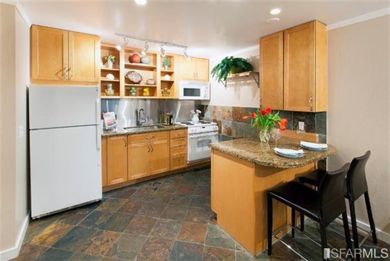 Remodeled kitchen with custom maple cabinet, granite counters and breakfast bar.