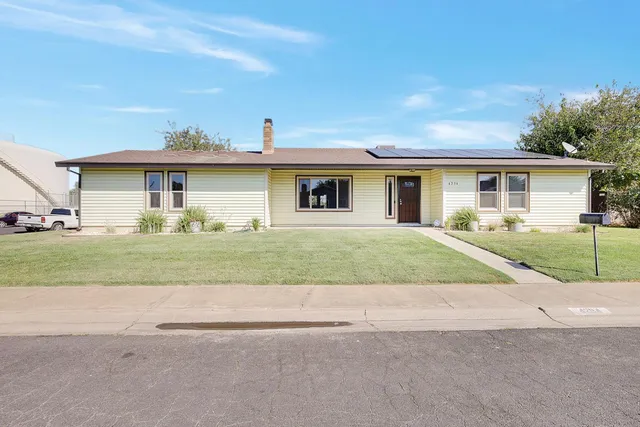 a view of house with a garden and pathway