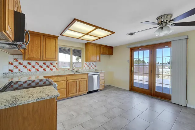 a kitchen with granite countertop a sink and a stove