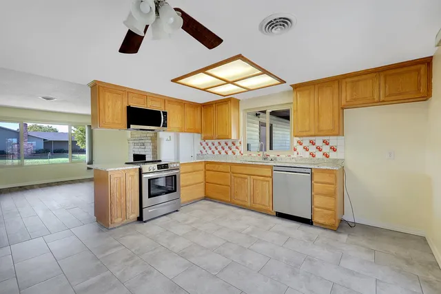 a kitchen with a stove a sink and a refrigerator