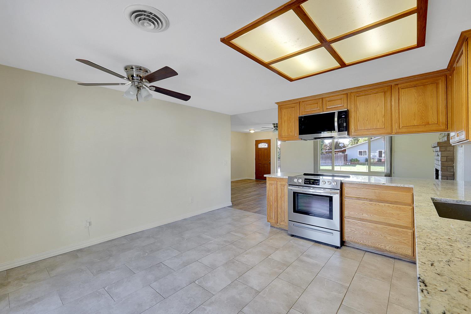 4294 Lever Avenue Olivehurst, CA 95961 - Photo 15 of 32 a living room with stainless steel appliances kitchen island granite countertop a sink and cabinets