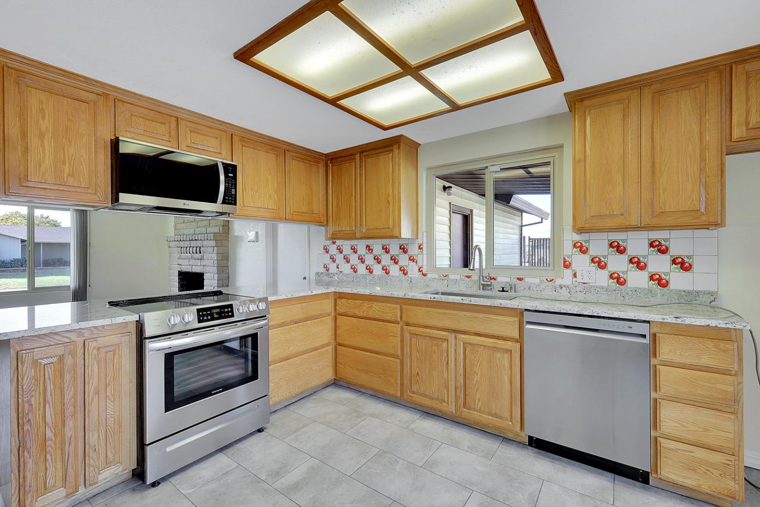 4294 Lever Avenue Olivehurst, CA 95961 - Photo 17 of 32 a kitchen with granite countertop cabinets stainless steel appliances and a sink