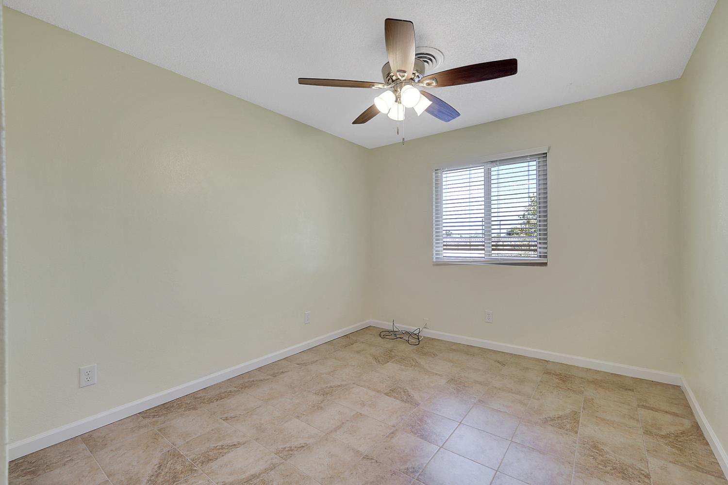 4294 Lever Avenue Olivehurst, CA 95961 - Photo 18 of 32 en view of an empty room with chandelier fan