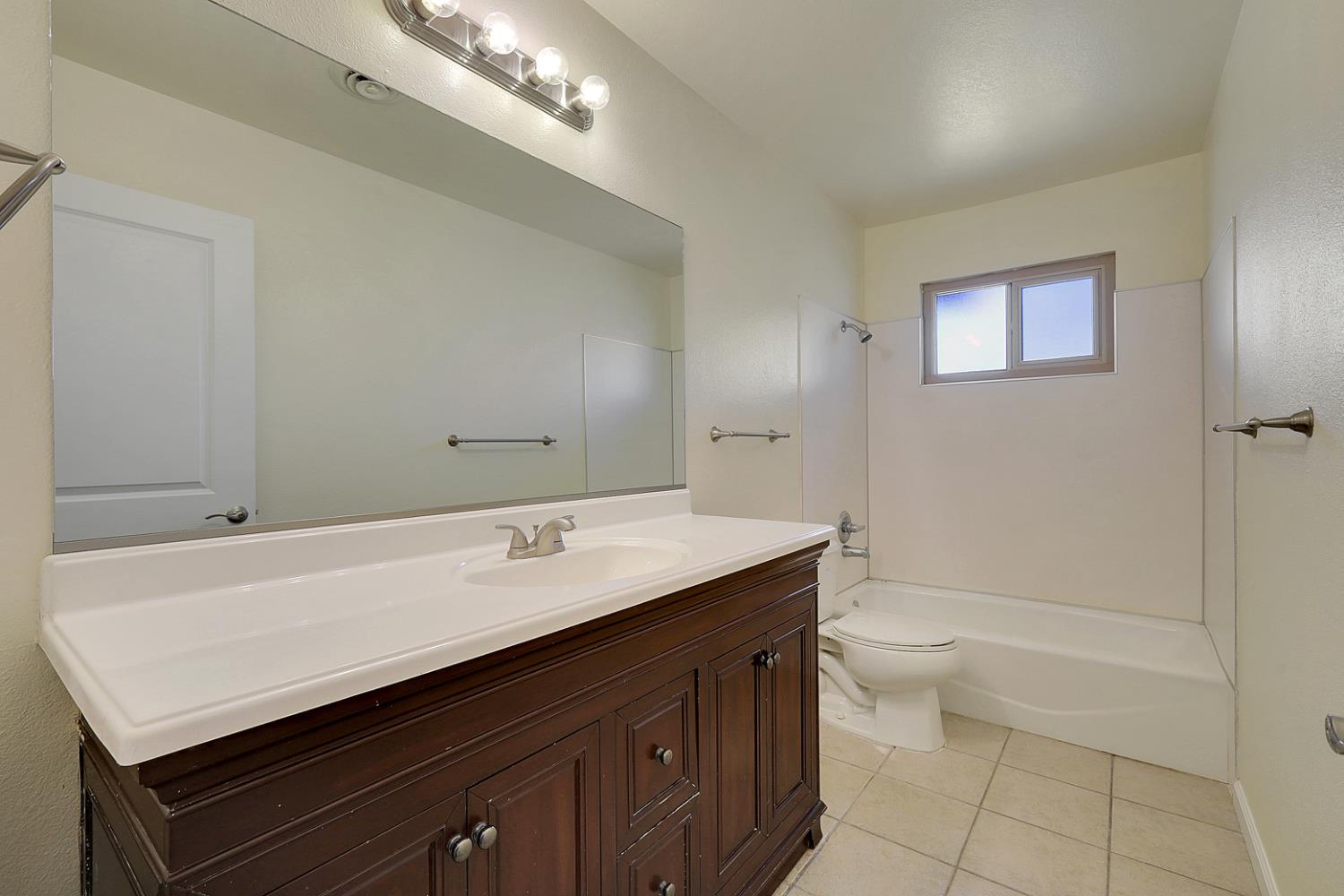 4294 Lever Avenue Olivehurst, CA 95961 - Photo 20 of 32 a bathroom with a sink a toilet and shower
