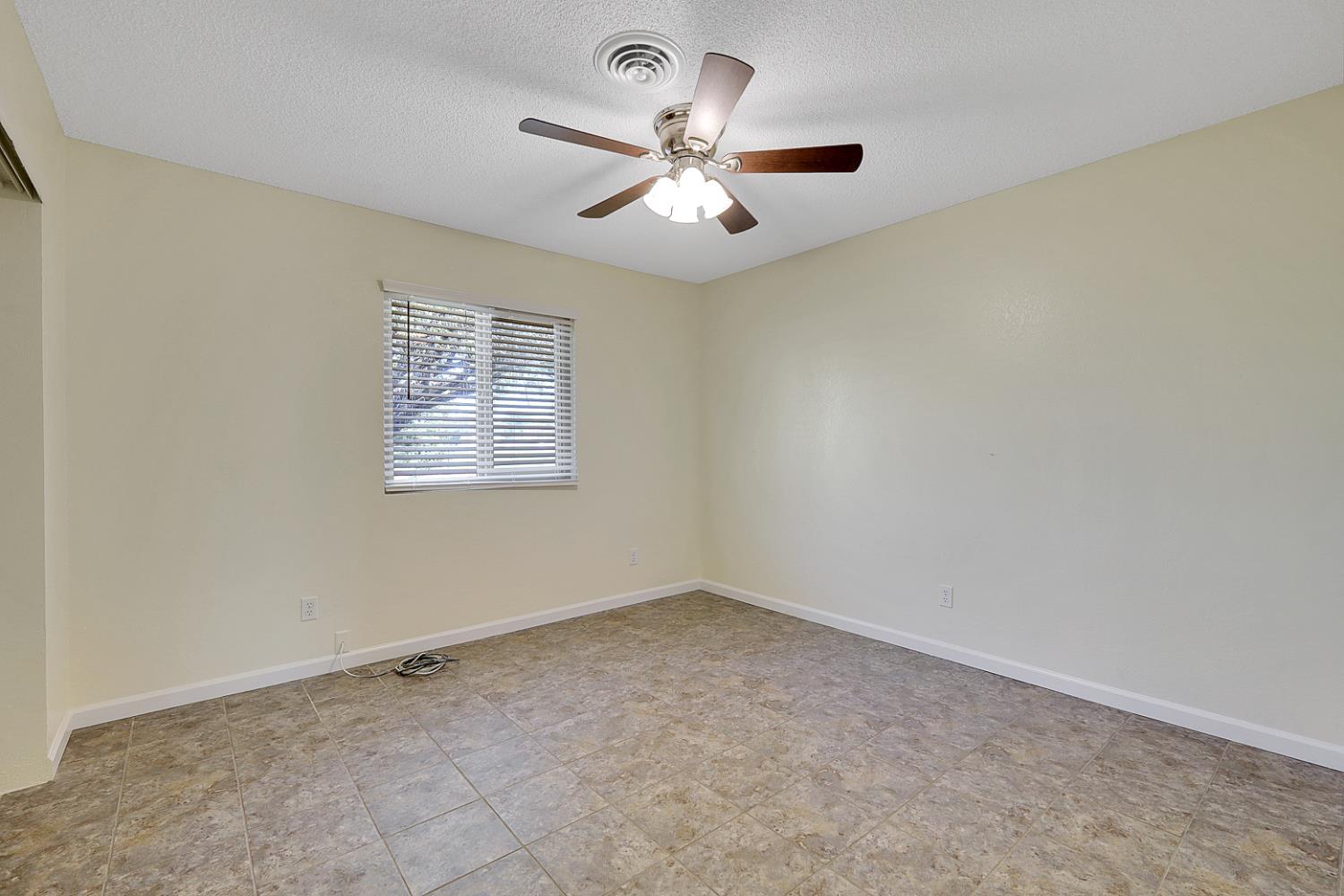 4294 Lever Avenue Olivehurst, CA 95961 - Photo 21 of 32 an empty room with a window and a fan