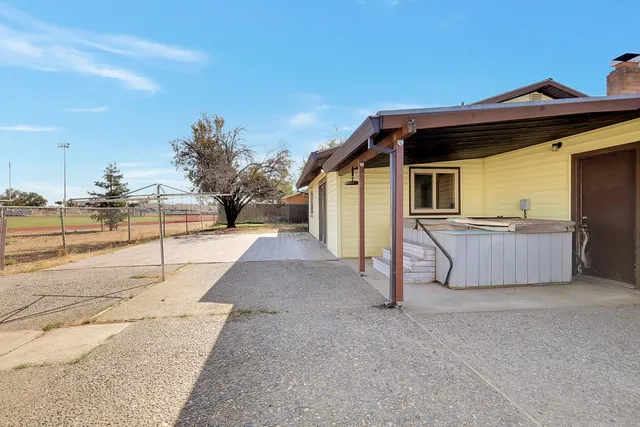 a view of a house with a sink and wooden fence