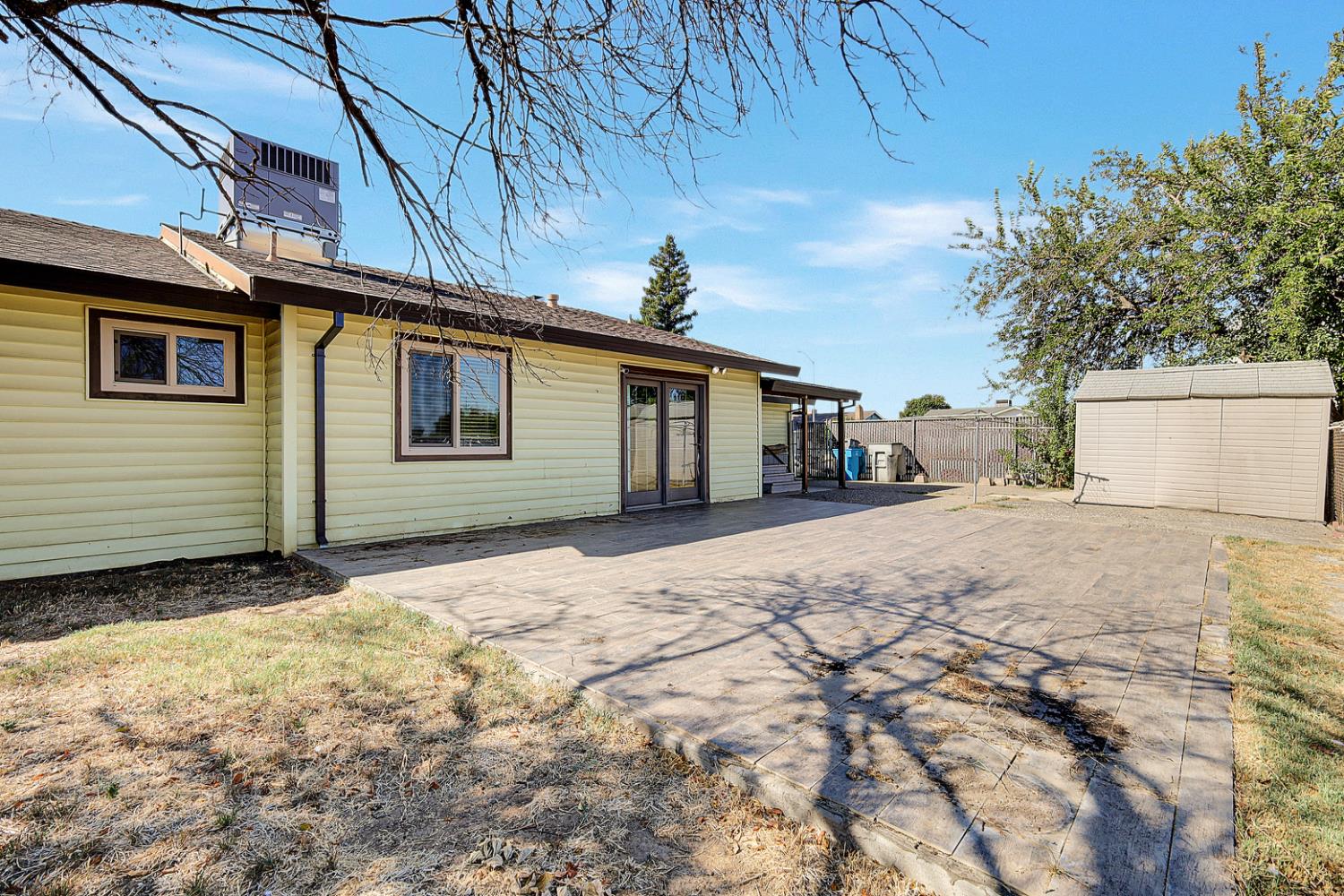 4294 Lever Avenue Olivehurst, CA 95961 - Photo 29 of 32 a backyard of a house with large trees and outdoor seating