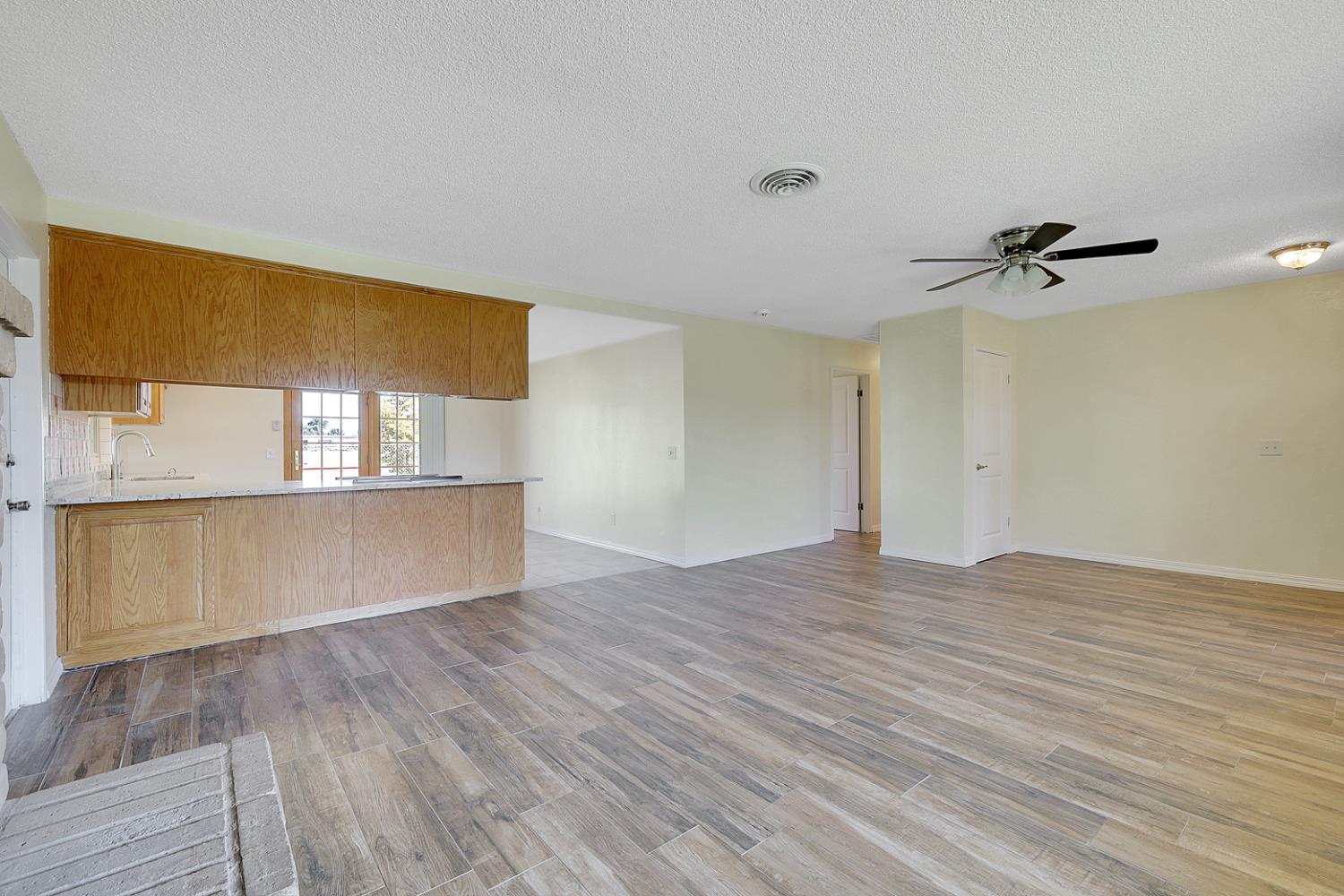 4294 Lever Avenue Olivehurst, CA 95961 - Photo 10 of 32 a view of an empty room with a window and wooden floor