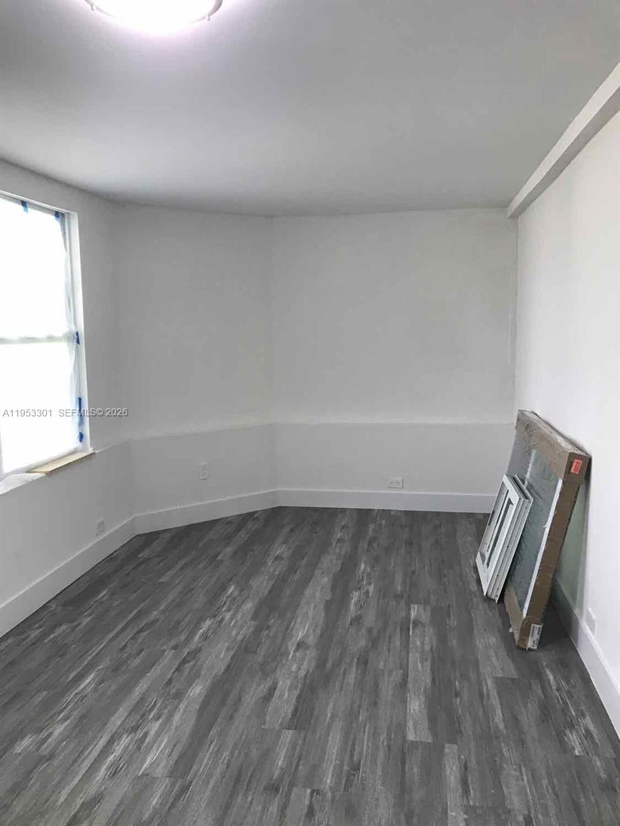 1920 Rutland Street Opa-Locka, FL 33054 - Photo 13 of 33 a view of a room with wooden floor and a window