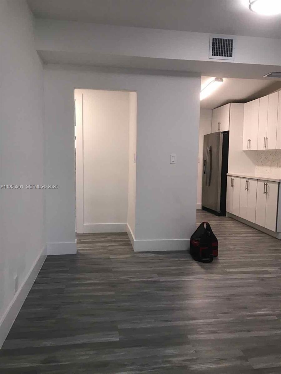 1920 Rutland Street Opa-Locka, FL 33054 - Photo 15 of 33 a view of an empty room and wooden floor