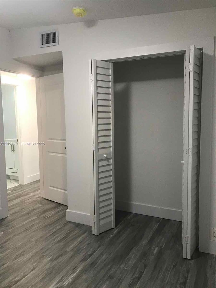 1920 Rutland Street Opa-Locka, FL 33054 - Photo 19 of 33 an empty room with wooden floor and closet