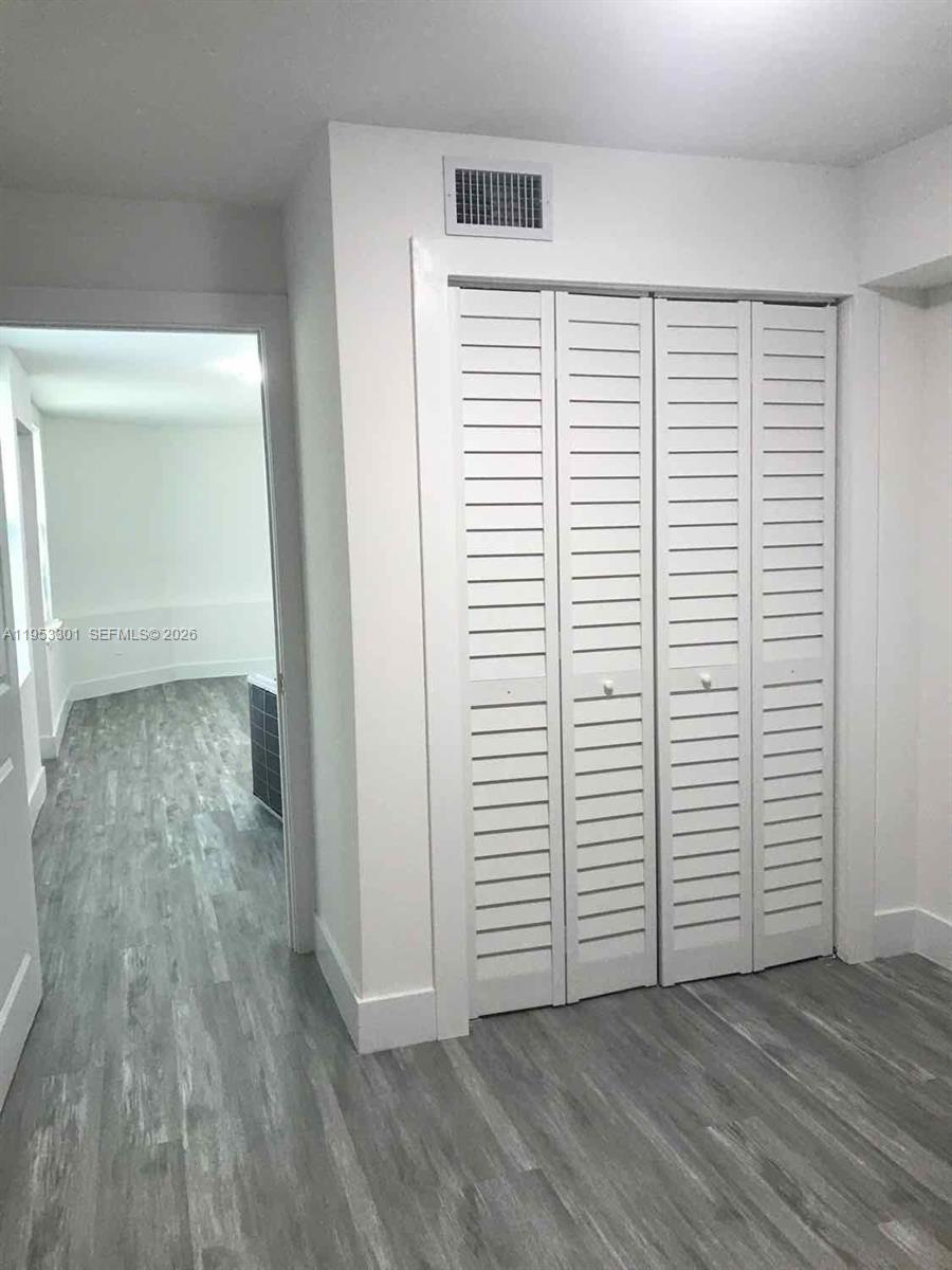 1920 Rutland Street Opa-Locka, FL 33054 - Photo 21 of 33 an empty room with wooden floor and closet