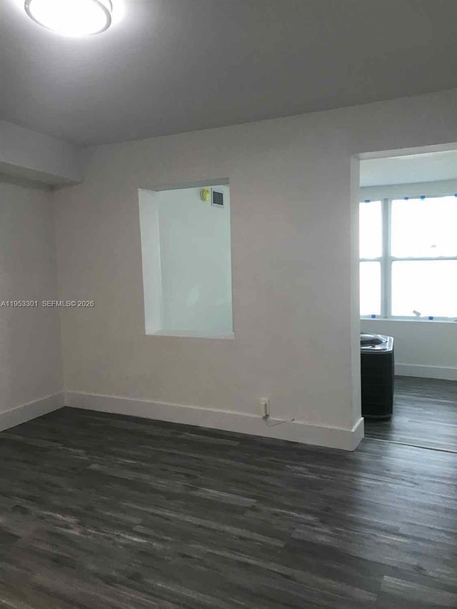 1920 Rutland Street Opa-Locka, FL 33054 - Photo 22 of 33 an empty room with wooden floor and windows