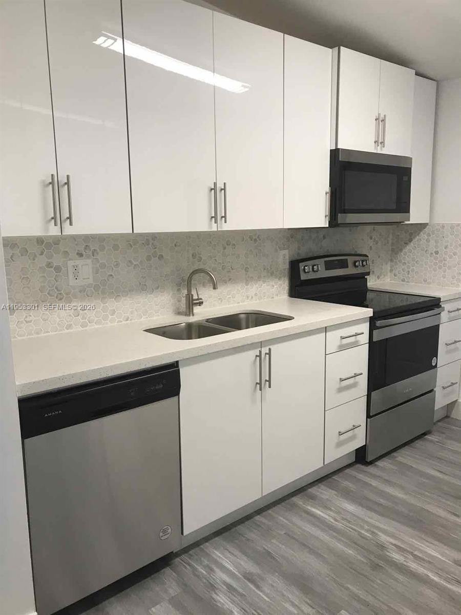 1920 Rutland Street Opa-Locka, FL 33054 - Photo 26 of 33 a kitchen with appliances cabinets and a sink