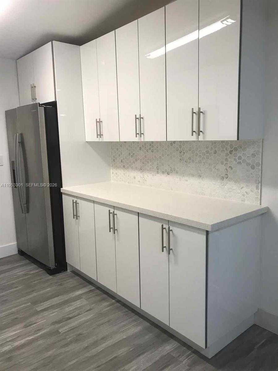 1920 Rutland Street Opa-Locka, FL 33054 - Photo 28 of 33 a kitchen with cabinets and stainless steel appliances