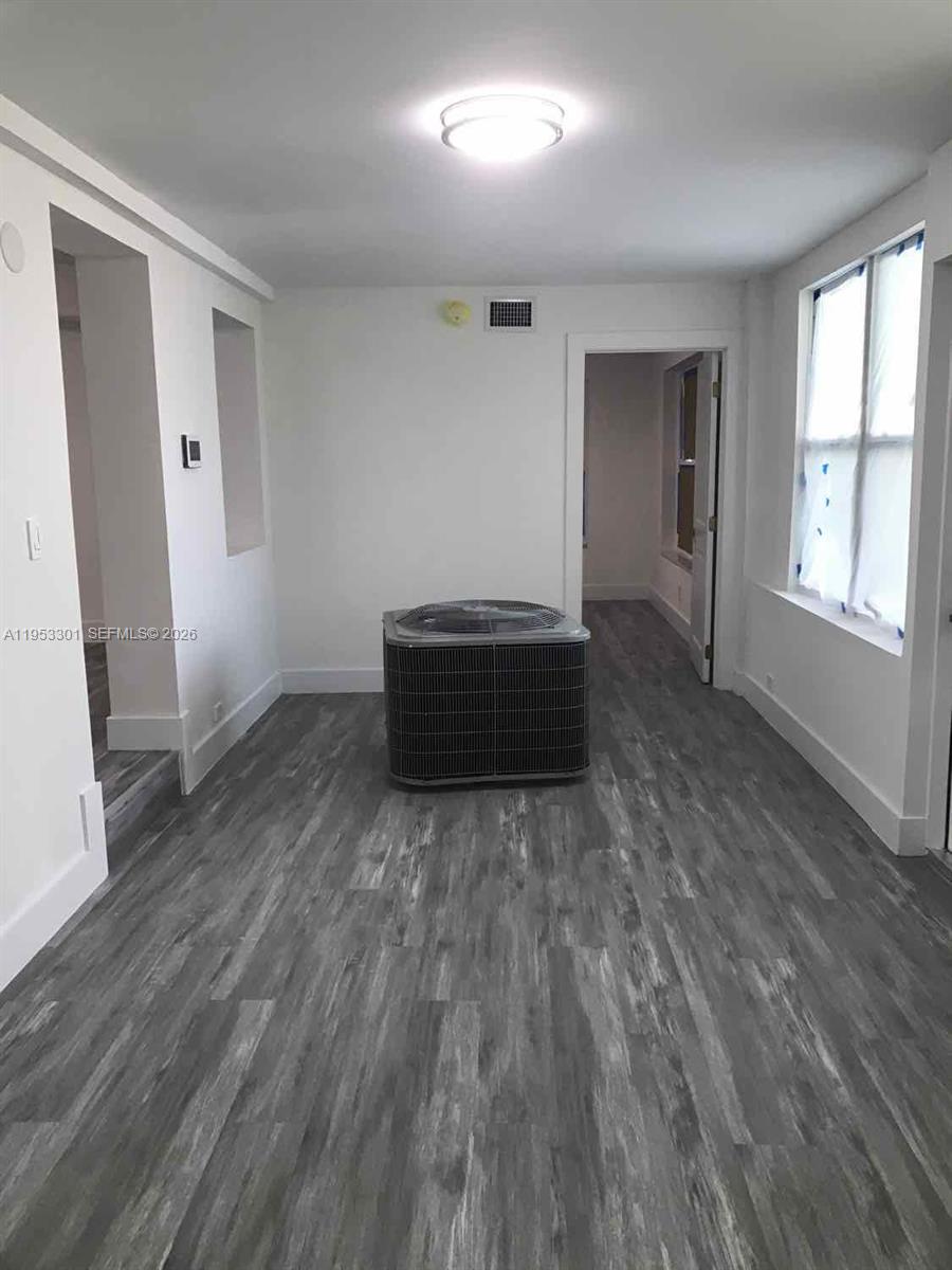 1920 Rutland Street Opa-Locka, FL 33054 - Photo 32 of 33 an empty room with wooden floor and windows