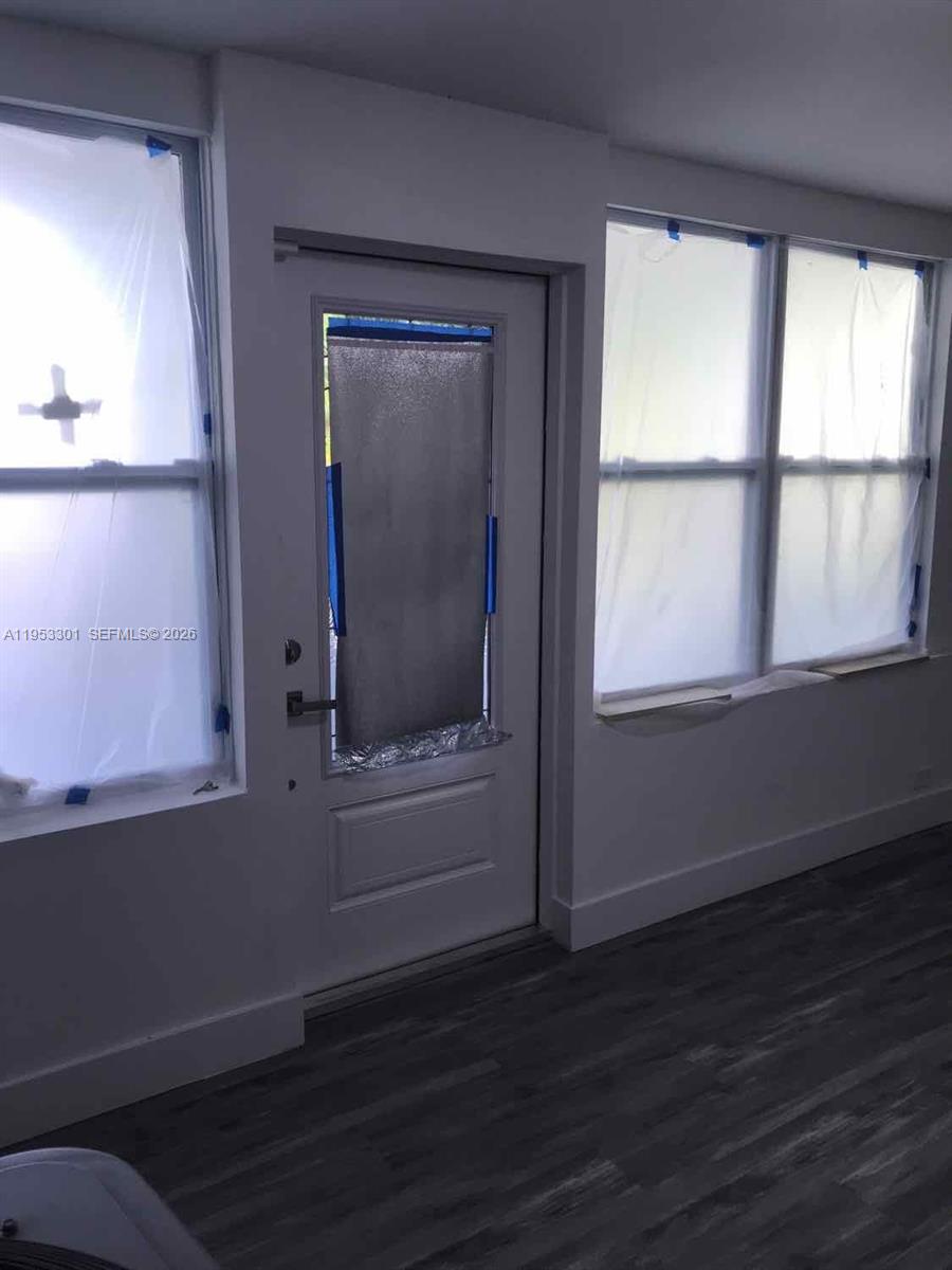 1920 Rutland Street Opa-Locka, FL 33054 - Photo 33 of 33 an empty room with wooden floor cabinet and windows