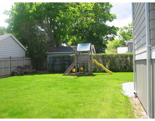 18 Homestead Road Marblehead, MA 01945 - Photo 11 of 15 a view of a backyard with a slide trees and wooden fence
