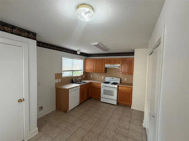 a kitchen with a stove and a refrigerator