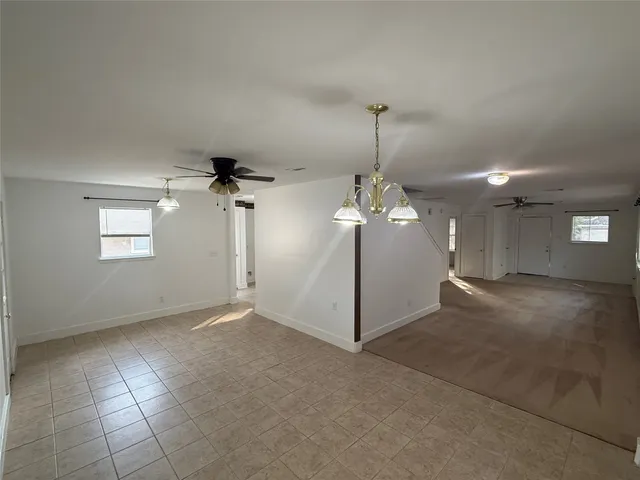 a view of a chandelier fan and a chandelier fan in a room