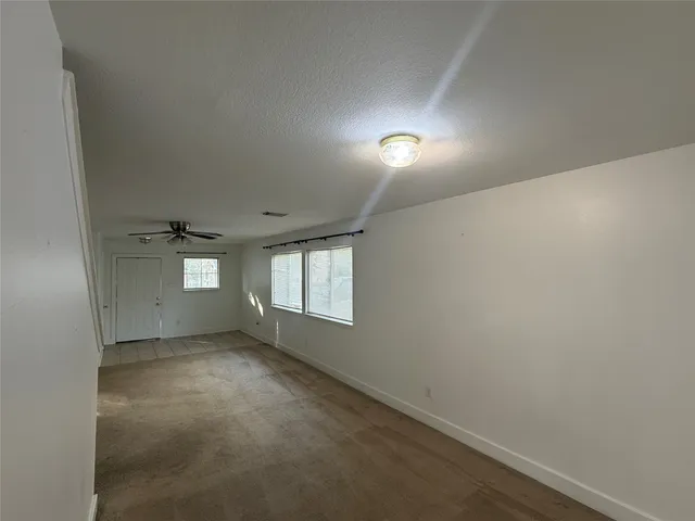 en empty room with windows and closet