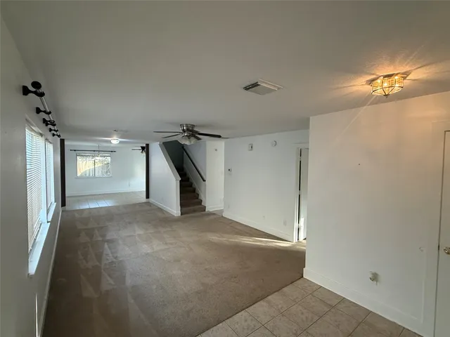 a view of empty room with a ceiling fan