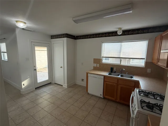 a room with a window and a kitchen