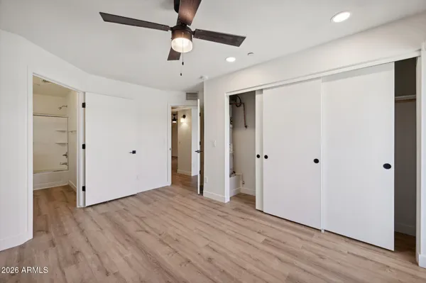a view of empty room with wooden floor