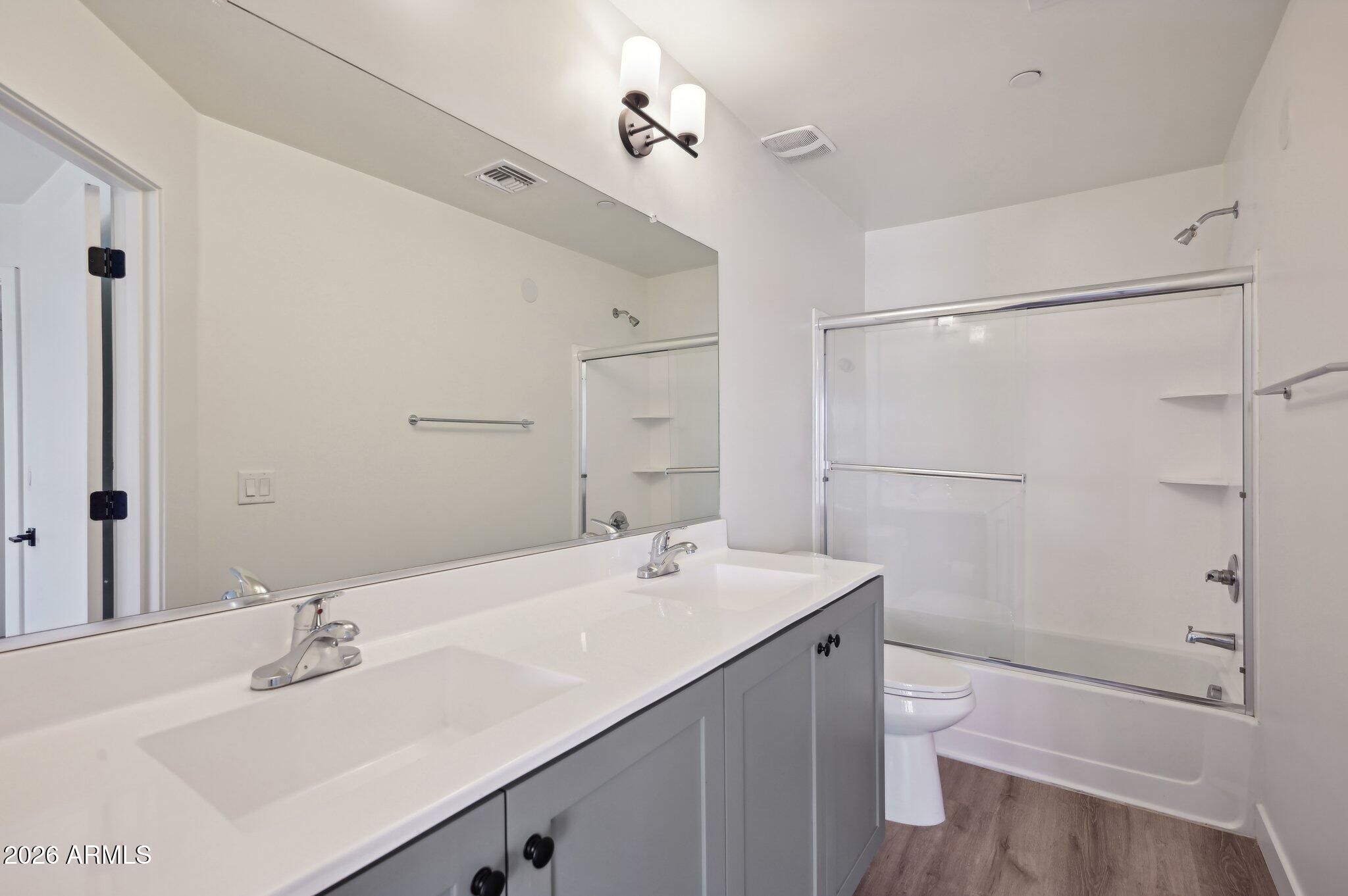 3644 East McDowell Road, Unit 101 Phoenix, AZ 85008 - Photo 14 of 21 a bathroom with a bathtub shower sink vanity mirror and toilet