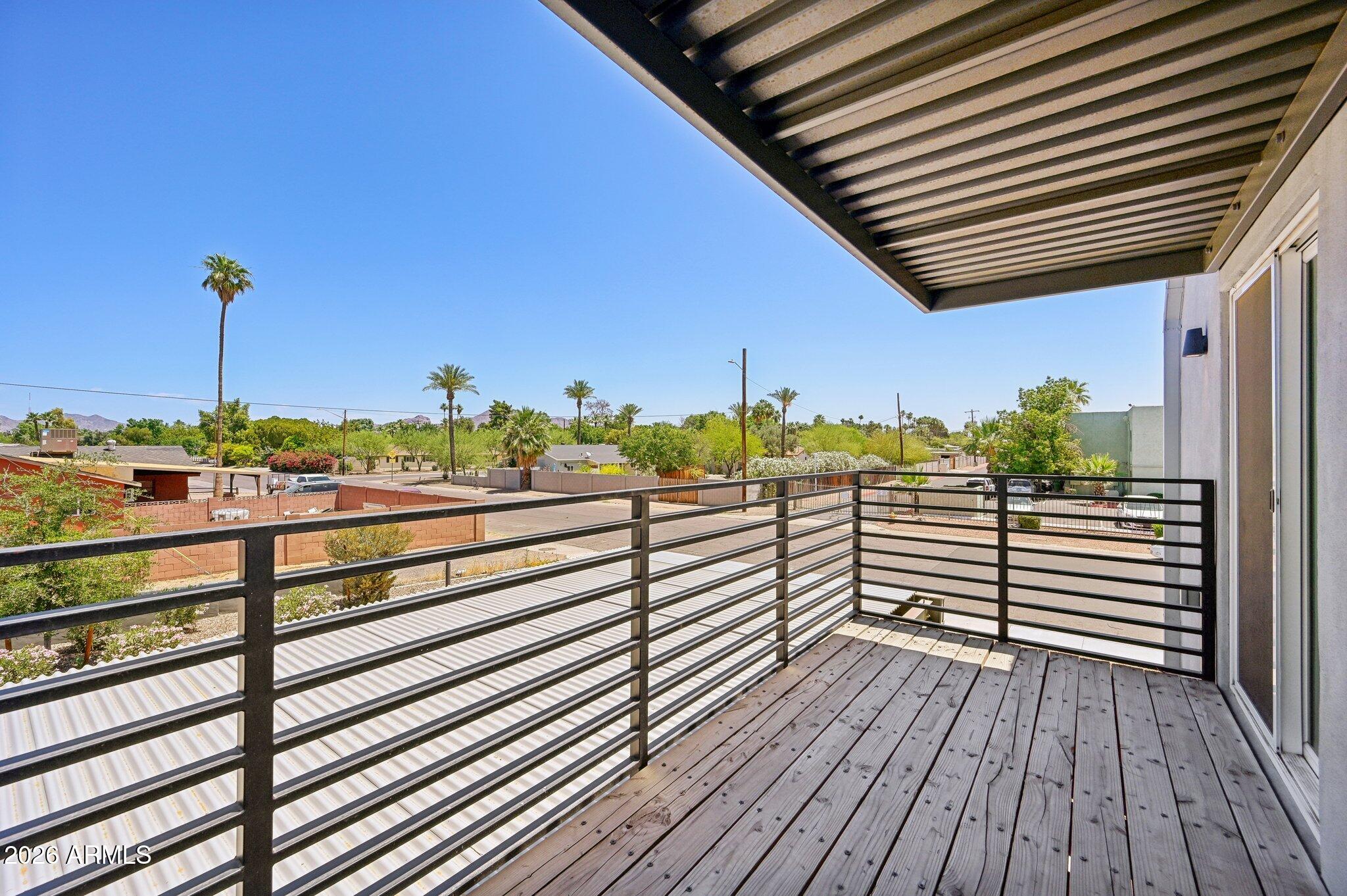 3644 East McDowell Road, Unit 101 Phoenix, AZ 85008 - Photo 15 of 21 a view of a balcony with wooden floor and potted plants