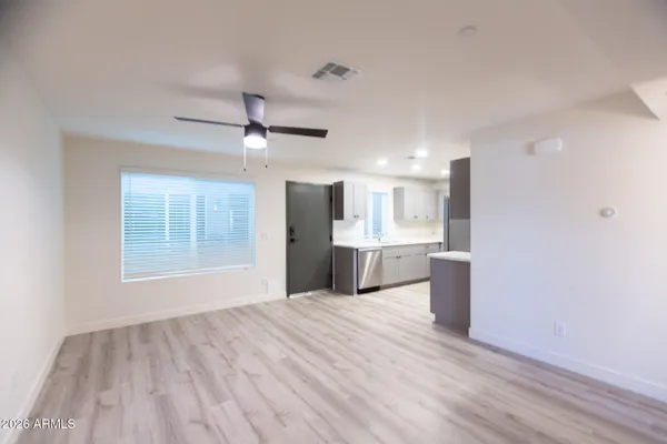 a view of kitchen with wooden floor and a window