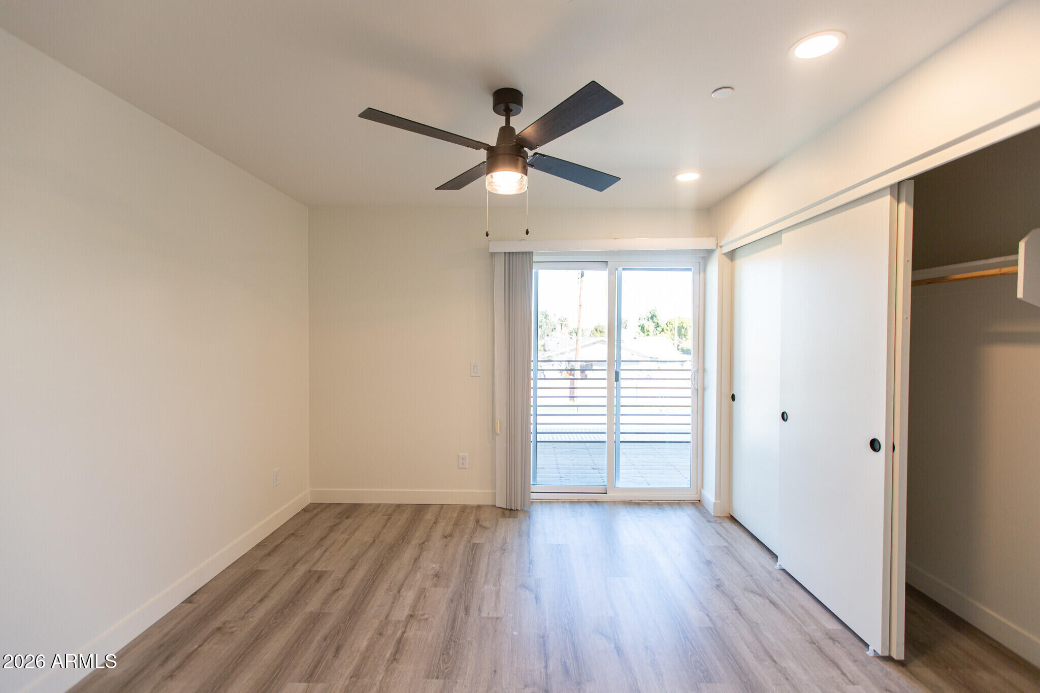 3644 East McDowell Road, Unit 101 Phoenix, AZ 85008 - Photo 19 of 21 a view of empty room with wooden floor and fan