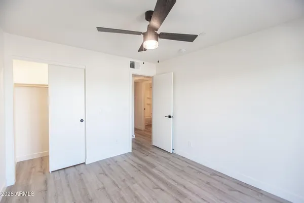 a view of an empty room and wooden floor