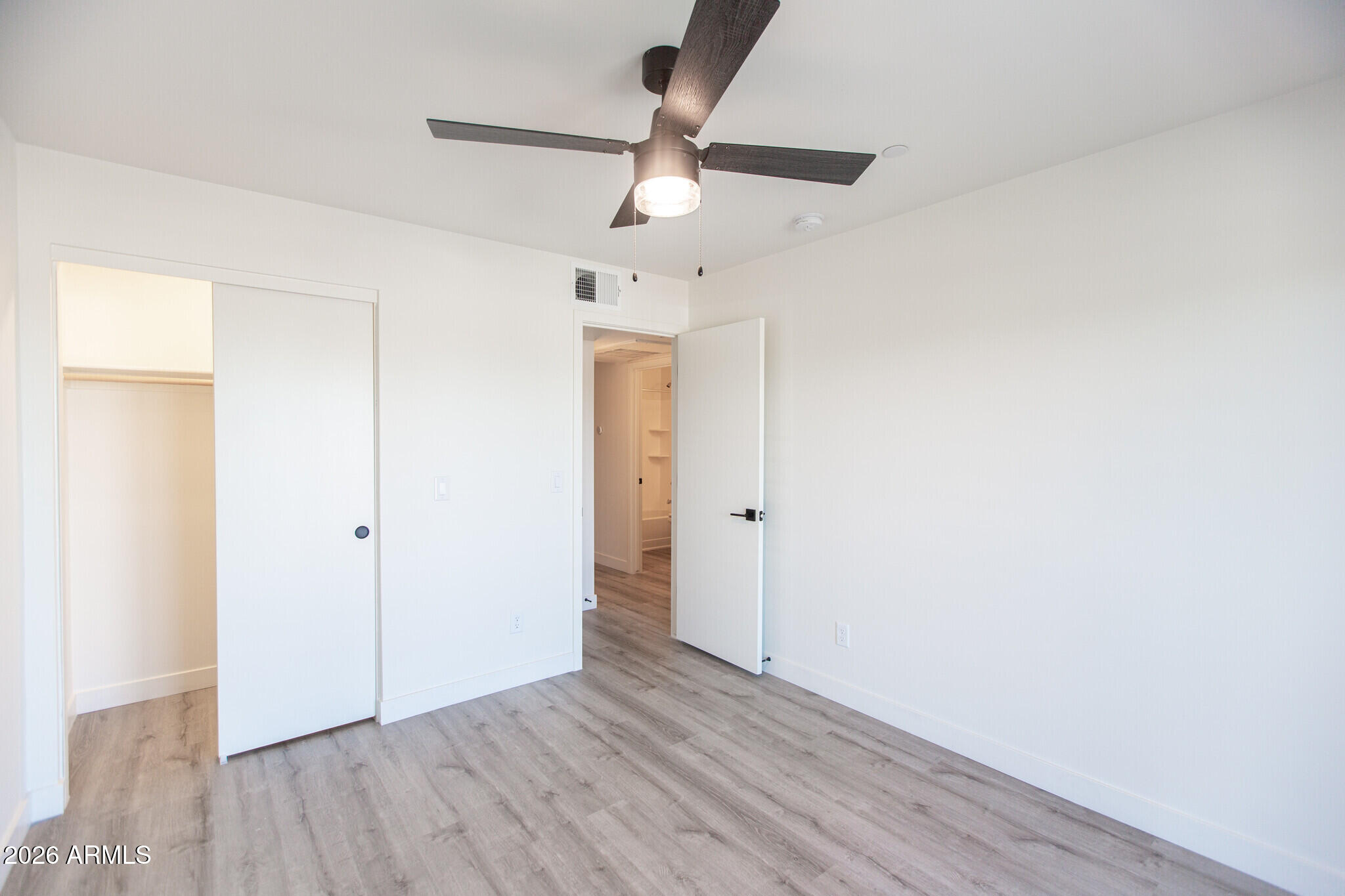 3644 East McDowell Road, Unit 101 Phoenix, AZ 85008 - Photo 21 of 21 a view of an empty room and wooden floor