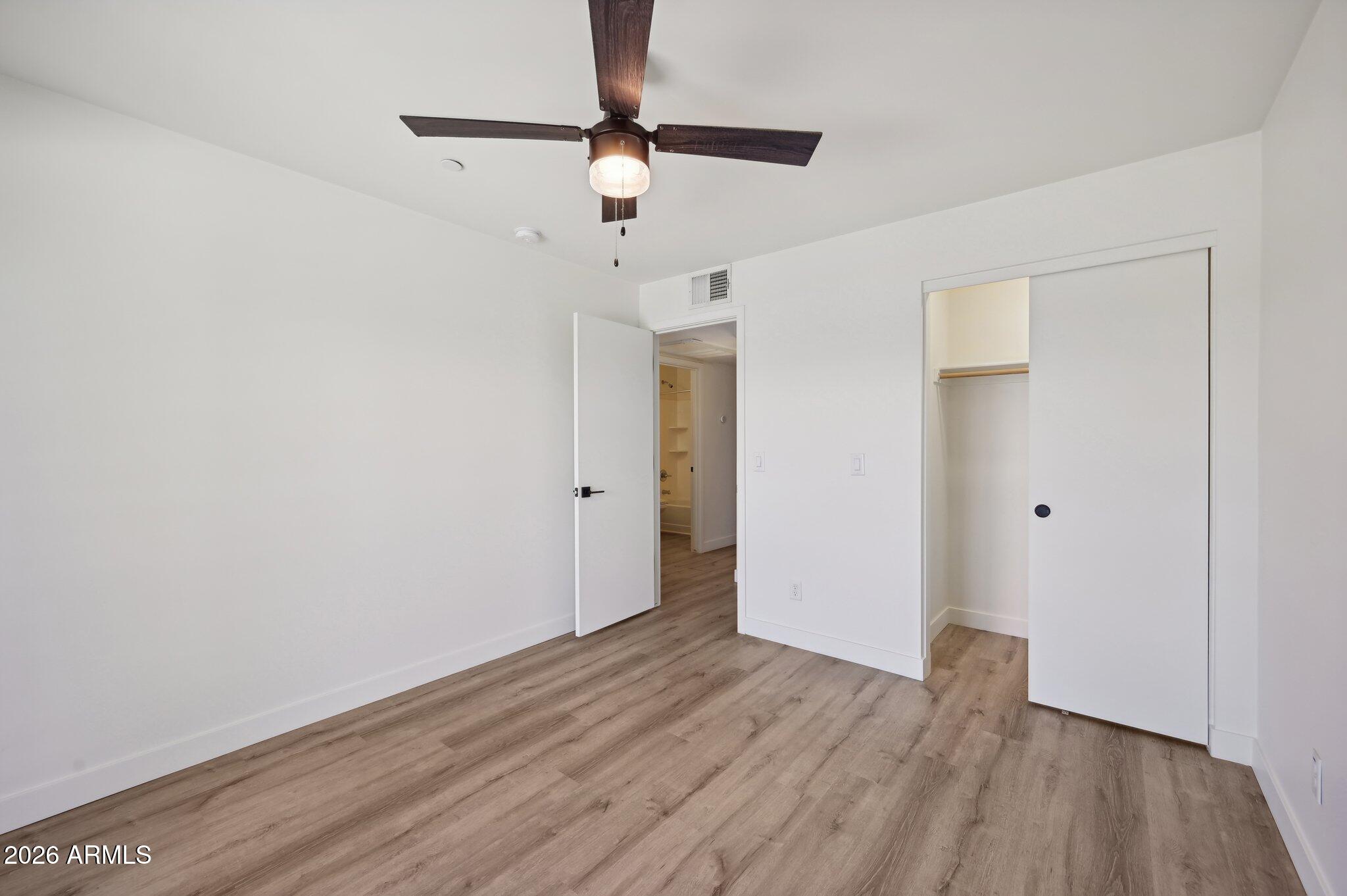 3644 East McDowell Road, Unit 101 Phoenix, AZ 85008 - Photo 9 of 21 a view of an empty room with wooden floor