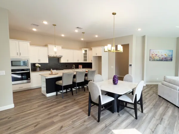 a living room with furniture a rug and a bookshelf
