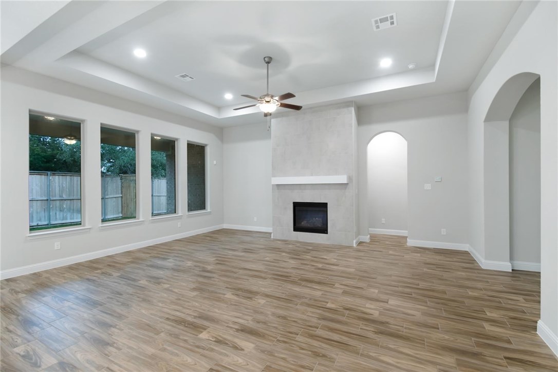 145 Lake Spring Circle Georgetown, TX 78633 - Photo 1 of 1 a view of empty room with wooden floor and fireplace