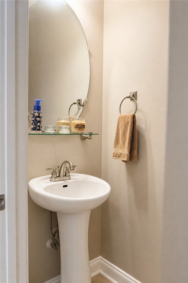 190 Fred Bradford Road Iva, SC 29655 - Photo 26 of 32 This bathroom features a contemporary pedestal sink and a sleek oval mirror.