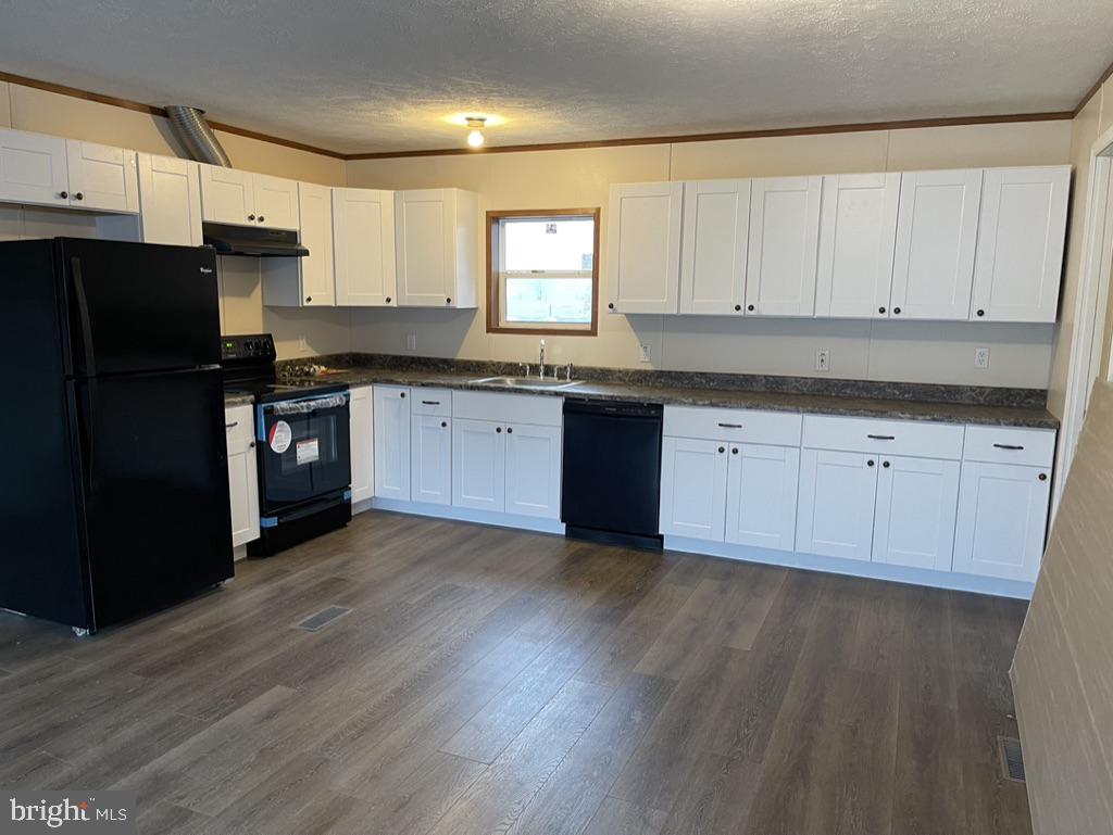 4250 Delta Road Airville, PA 17302 - Photo 2 of 12 a kitchen with granite countertop white cabinets and black stainless steel appliances