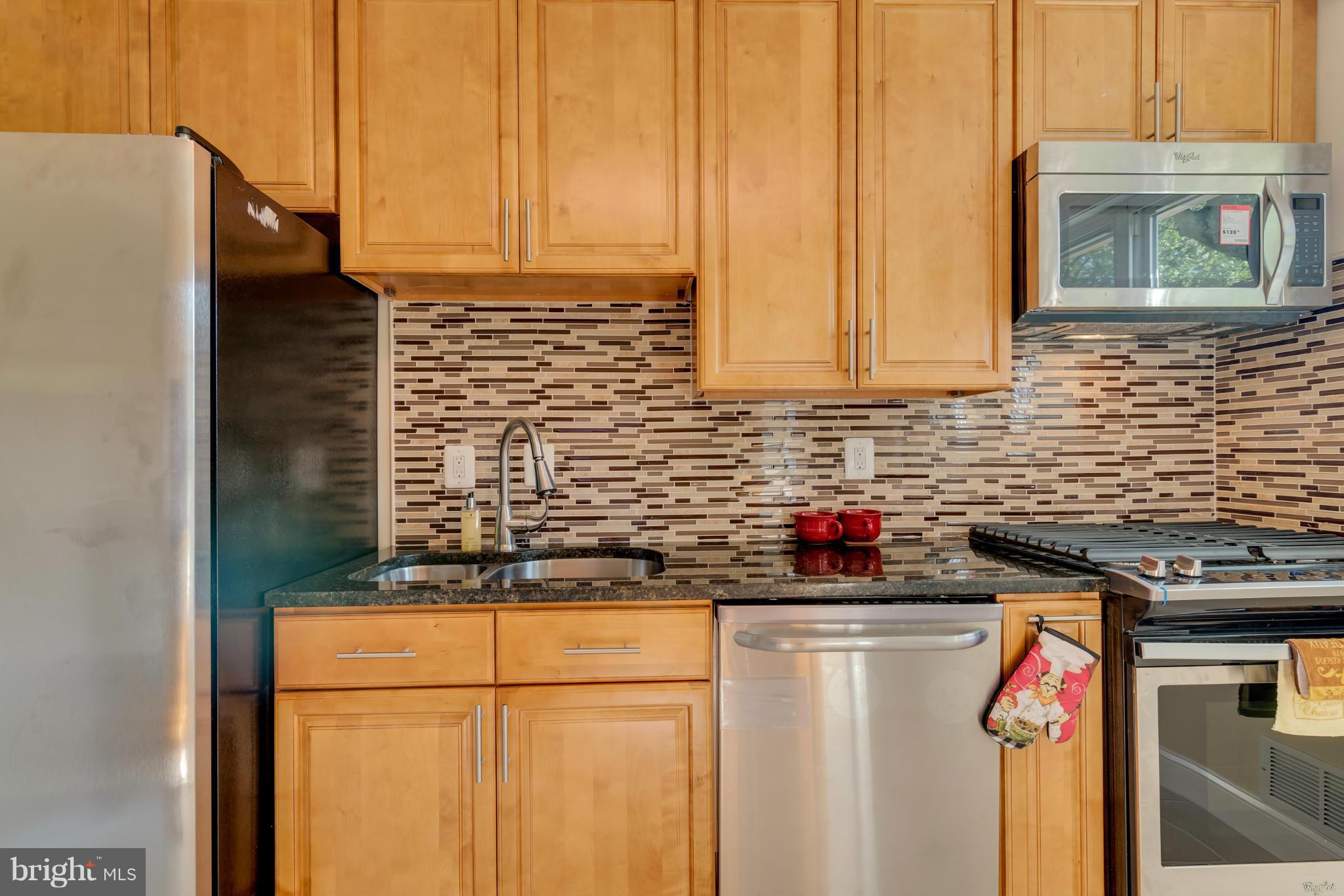 3310 Harrell Street Silver Spring, MD 20906 - Photo 2 of 26 a kitchen with stainless steel appliances granite countertop a stove and a refrigerator