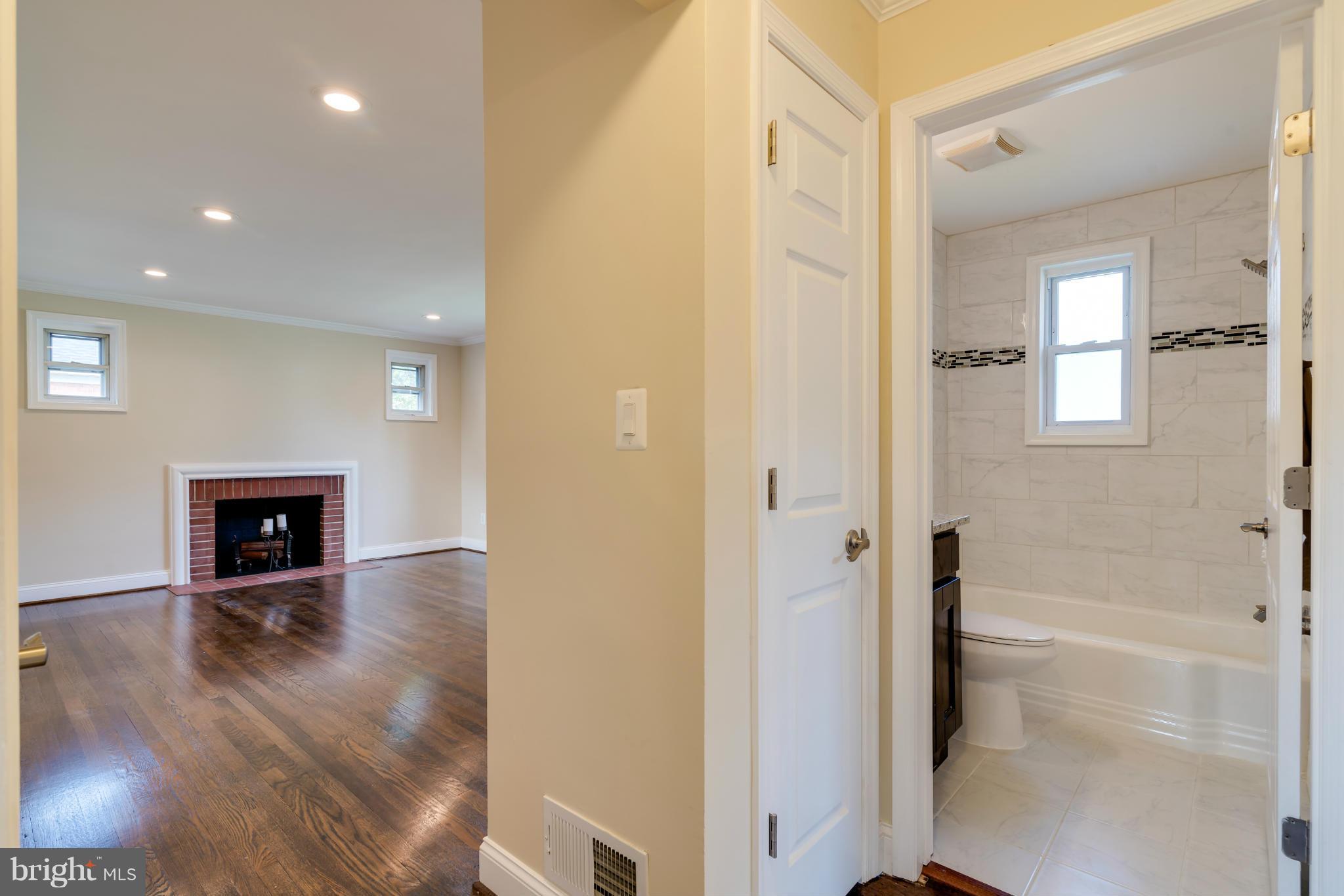 3310 Harrell Street Silver Spring, MD 20906 - Photo 11 of 26 a view of an empty room with wooden floor and a fireplace